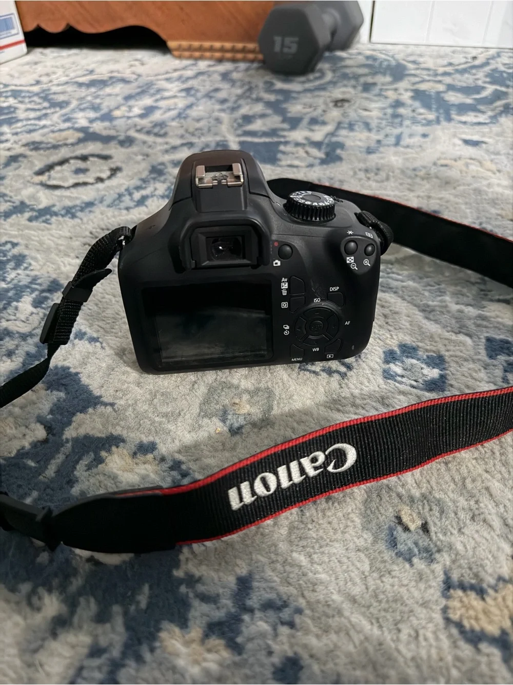 Canon EOS RebelT100 DSLR Camera with Kit Zoom Lens and Red-Trim Strap